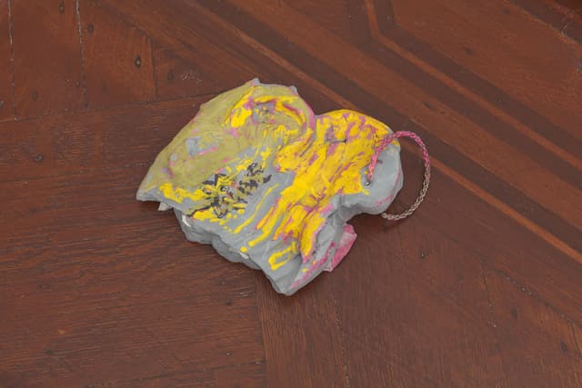 Laura McCoy. Capital Problem (Detail), 2022. Clay, acrylic paint, plastic, flowers. Dimensions variable.