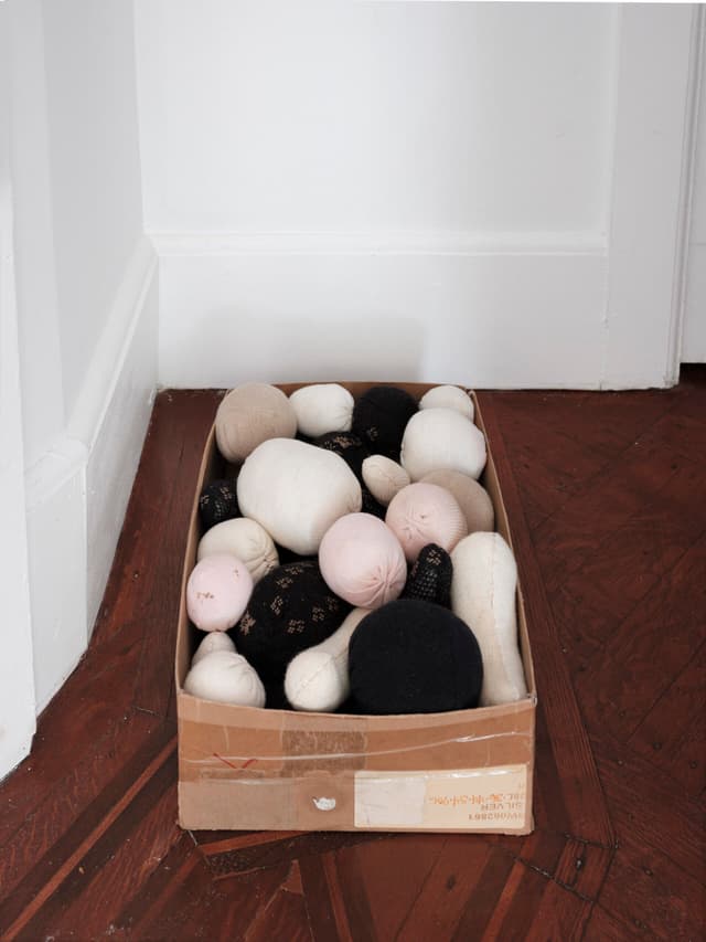 Winona Sloane Odette. Untitled, 2023. Trimmings/notions box, socks, cotton/poly batting. 12.5 x 8 x 5 inches.