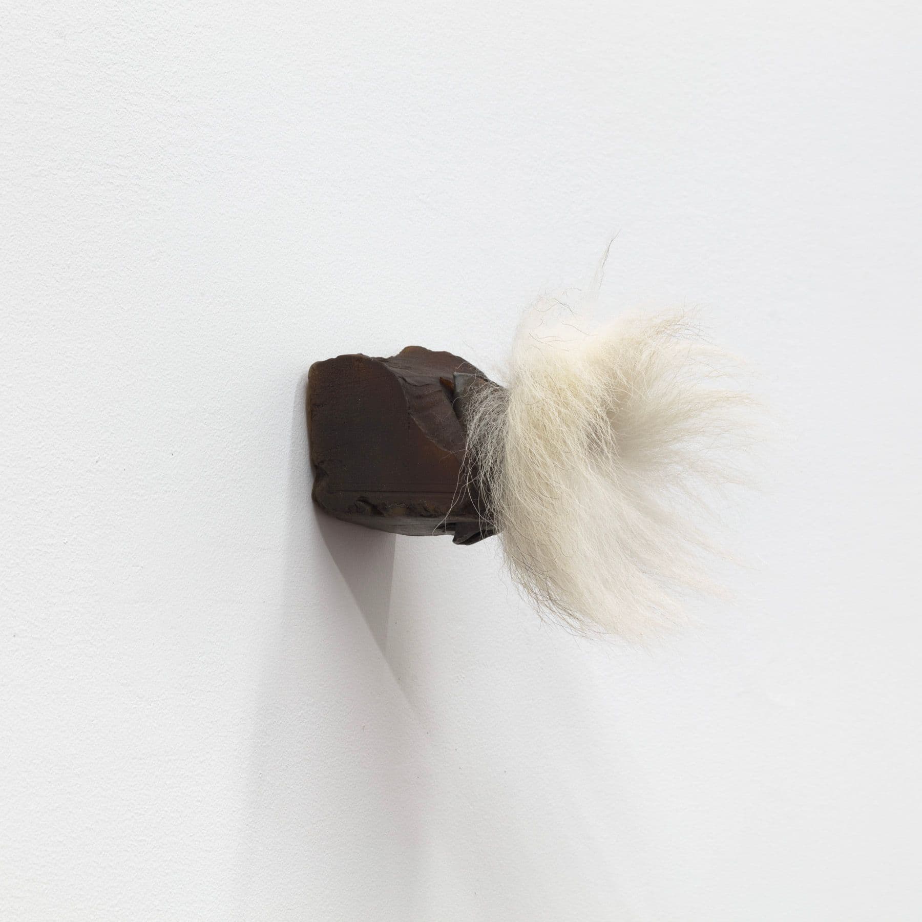 Winona Sloane Odette. Untitled, 2022. Beeswax, pigment, eyeshadow, found bell, fox tail, tack. 4 x 3 x 5 inches.