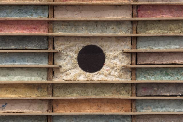 Bronson Smillie. Debris Flow Hotel (Detail), 2023. Modified cassette storage case, paper pulp, bar rag, postage stamp, felt pad. 18.5 x 24 x 3 inches.