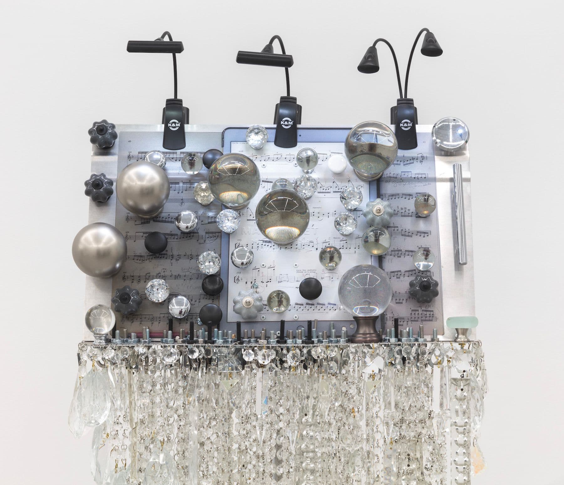 Scott Keightley. Amid a Place of Stone (Detail), 2021. Laser print on Manhasset music stand, glass, finials, hardware, and stand lights. 62 x 21 x 18 inches.