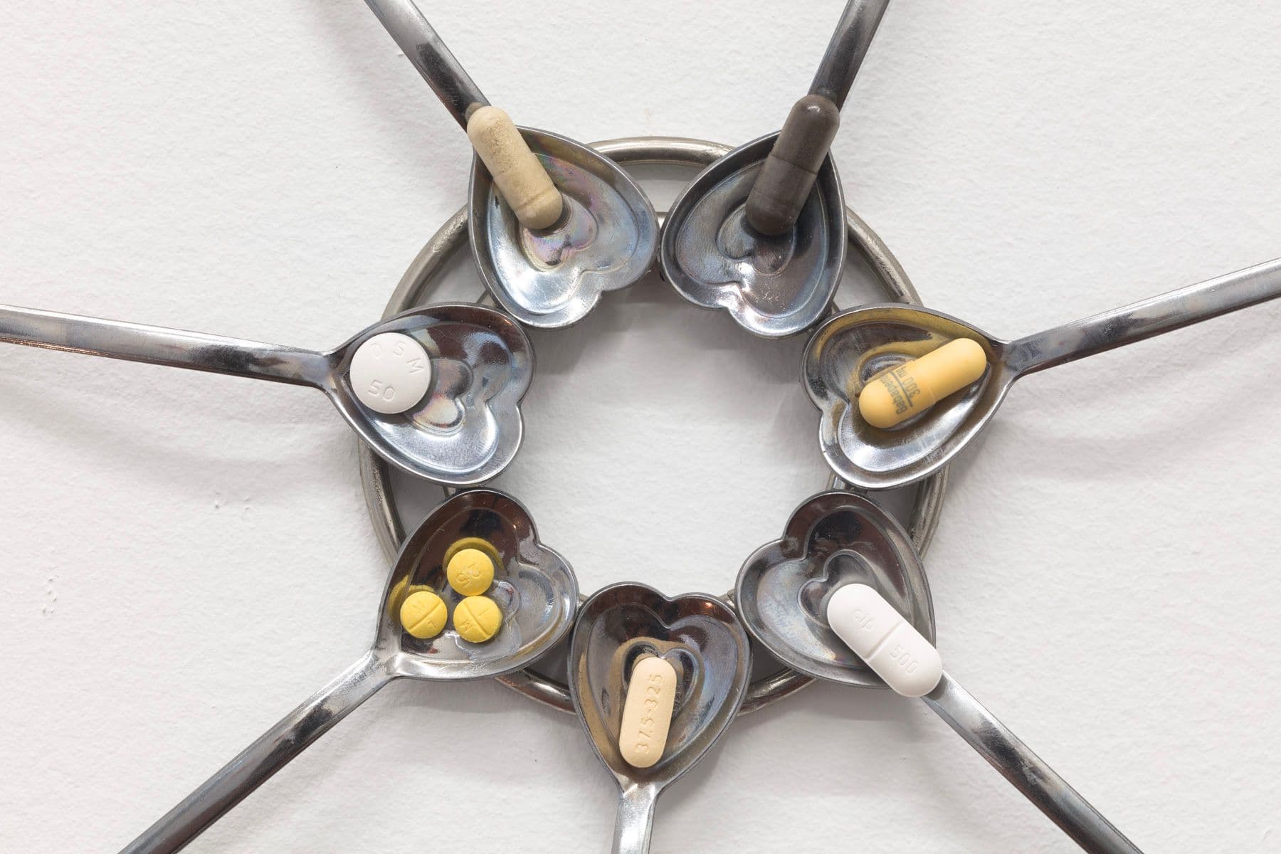 Sharona Franklin. Compassion Crip Clock (Detail), 2021. Spoons, metal alloy, expired pharmaceuticals. 11.5 x 11.5 inches.