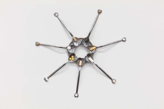 Sharona Franklin. Compassion Crip Clock (Detail), 2021. Spoons, metal alloy, expired pharmaceuticals. 11.5 x 11.5 inches.