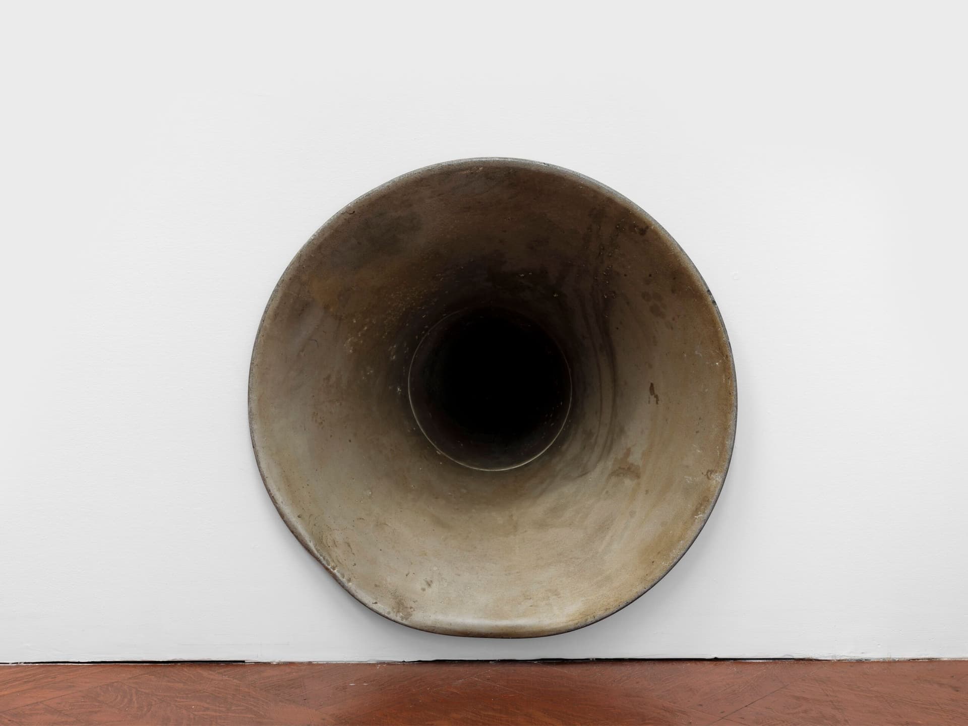 Winona Sloane Odette. Untitled (Detail), 2023. Silver plated dog bowl, phonograph horn, drywall. Dimensions variable.