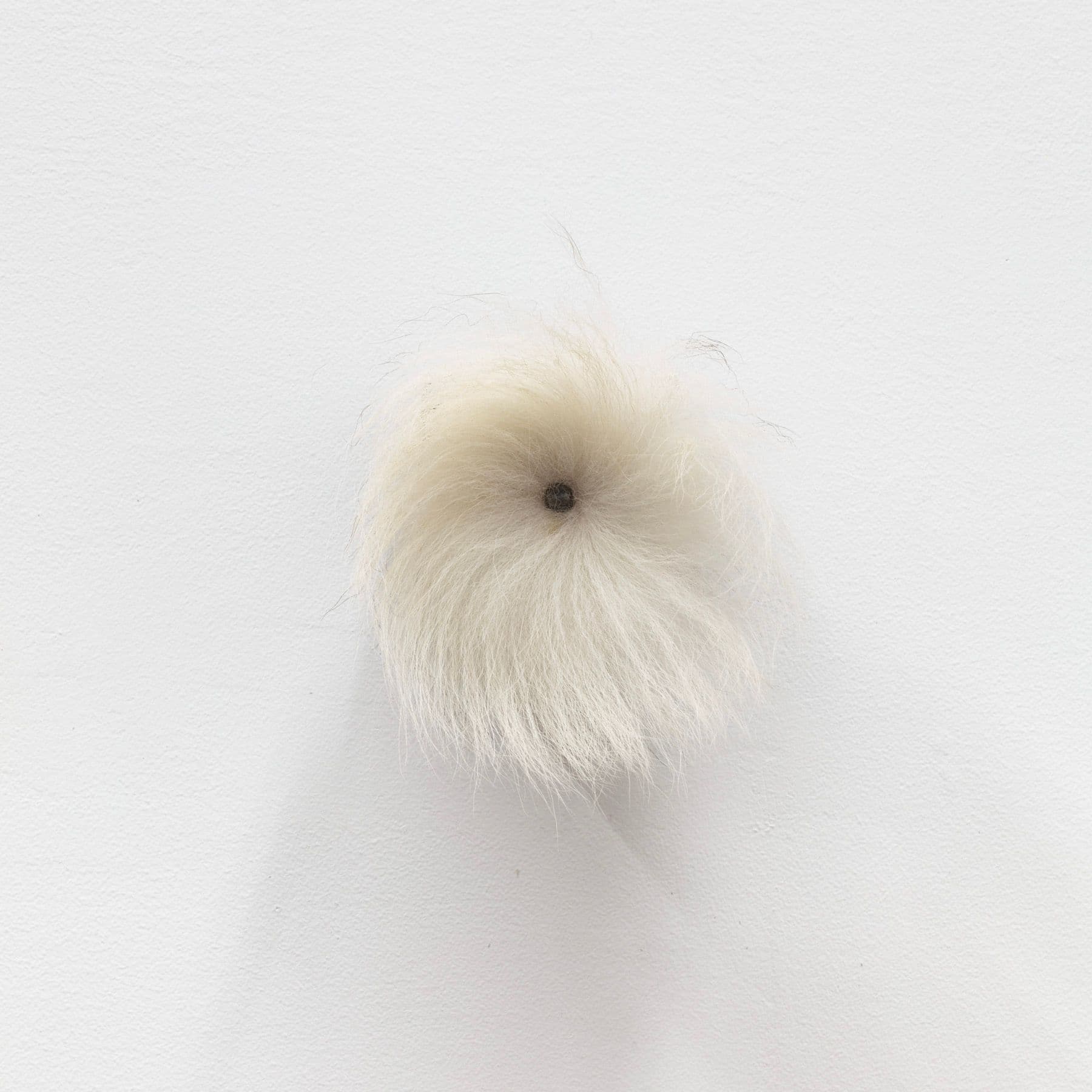 Winona Sloane Odette. Untitled, 2022. Beeswax, pigment, eyeshadow, found bell, fox tail, tack. 4 x 3 x 5 inches.