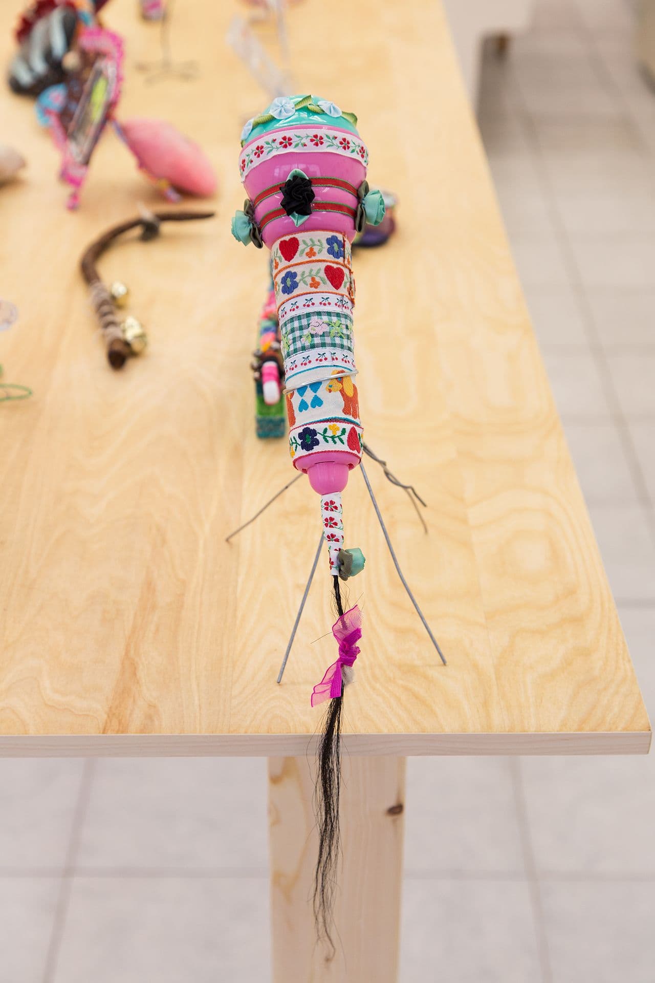 Alix Van Der Donckt-Ferrand. Untitled, 2023. Plastic microphone, ribbons, glue, horse hair, dog hair, wire. 11 x 13 x 6 inches.