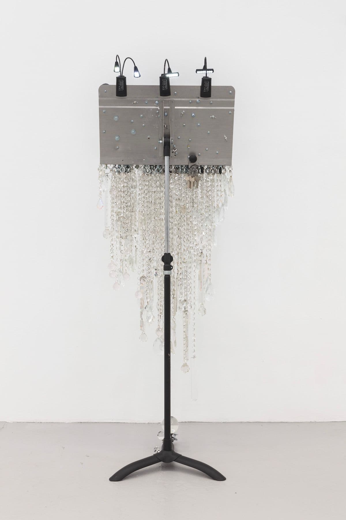 Scott Keightley. Amid a Place of Stone, 2021. Laser print on Manhasset music stand, glass, finials, hardware, and stand lights. 62 x 21 x 18 inches.