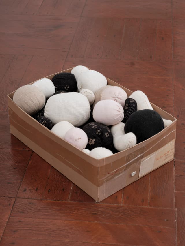 Winona Sloane Odette. Untitled, 2023. Trimmings/notions box, socks, cotton/poly batting. 12.5 x 8 x 5 inches.