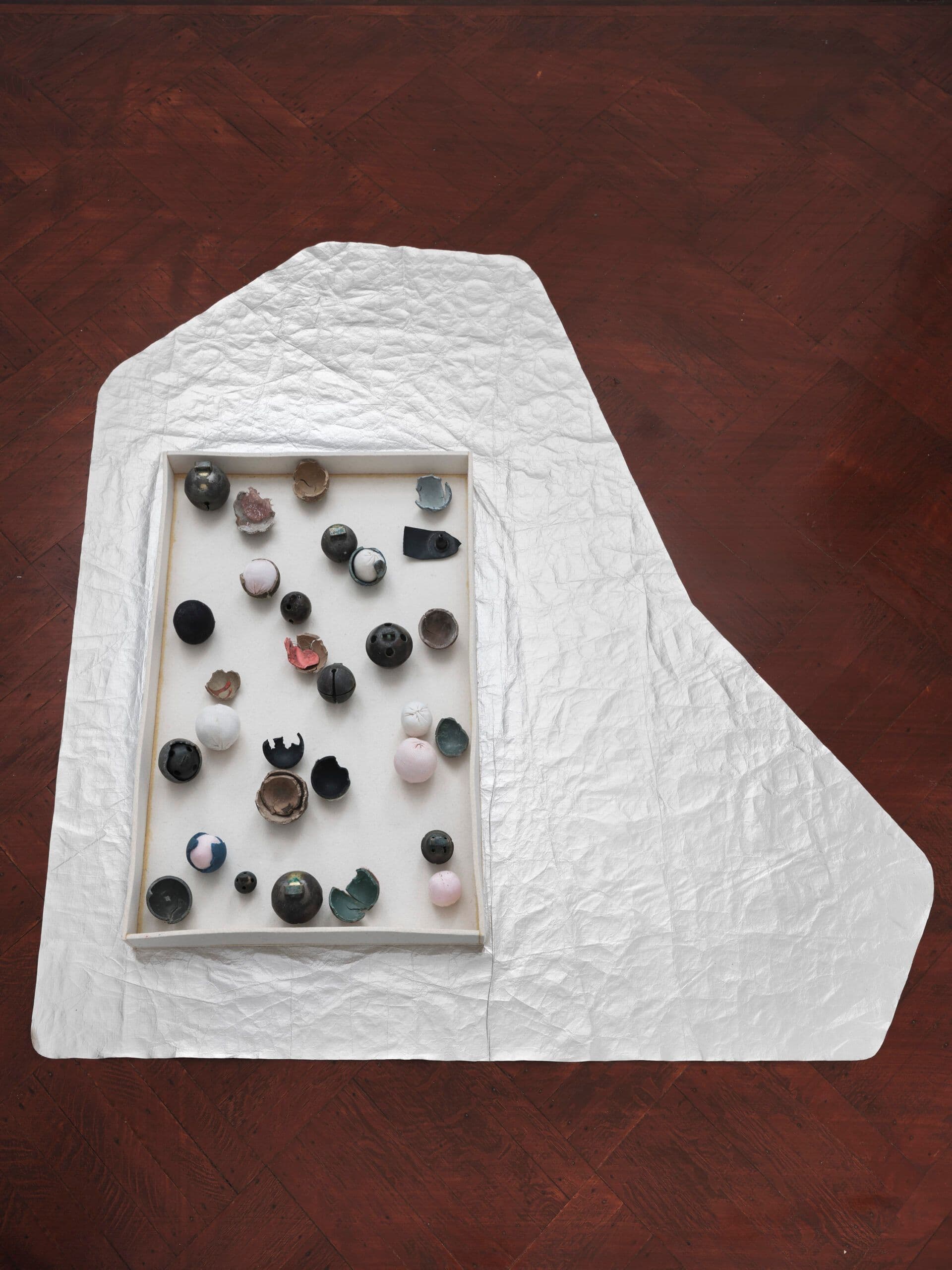 Winona Sloane Odette. Untitled, 2023. Tvyek, industrial felt, rubber ball discards, assorted bells, socks, poly batting. 48 x 56 x 1.5 inches.