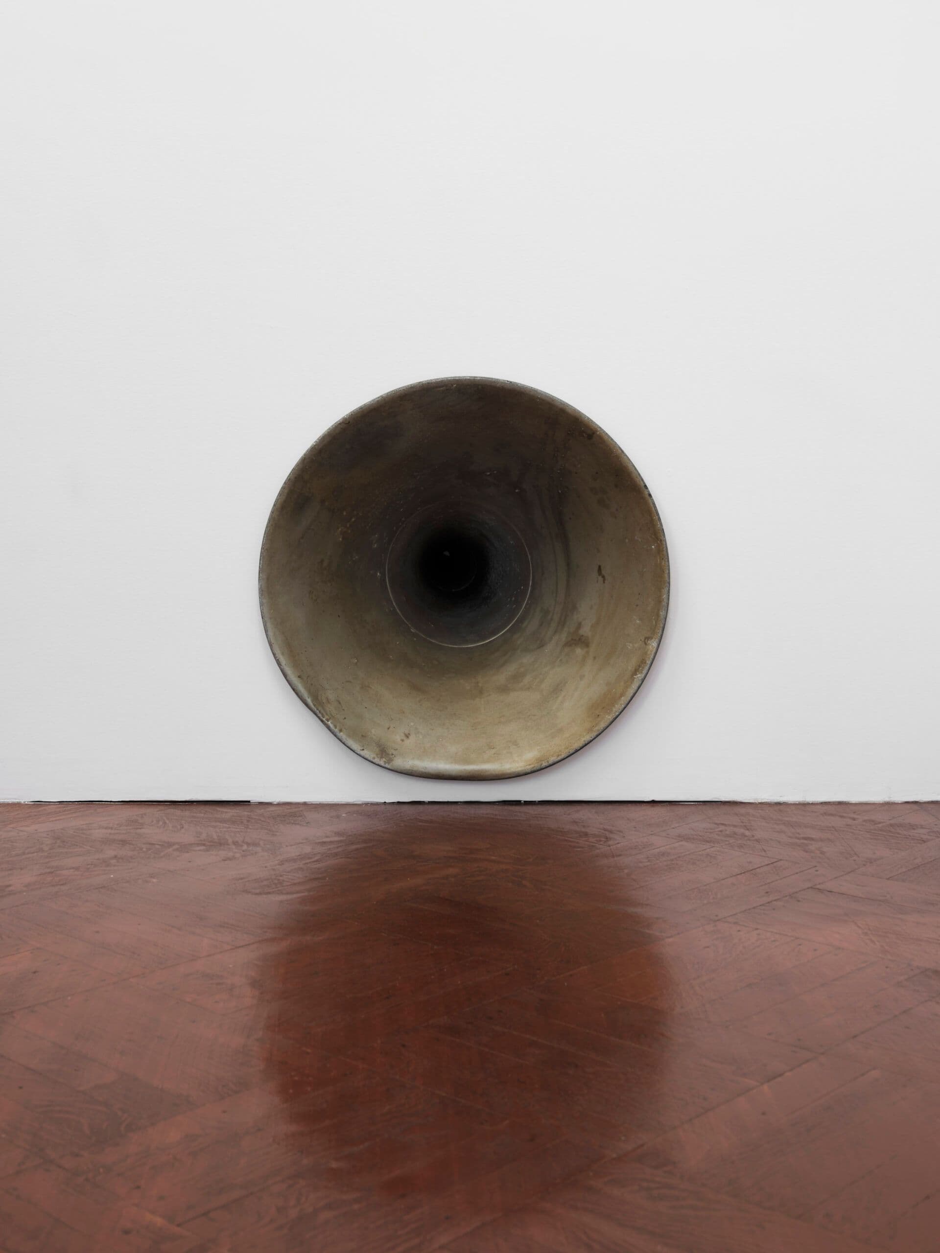 Winona Sloane Odette. Untitled (Detail), 2023. Silver plated dog bowl, phonograph horn, drywall. Dimensions variable.