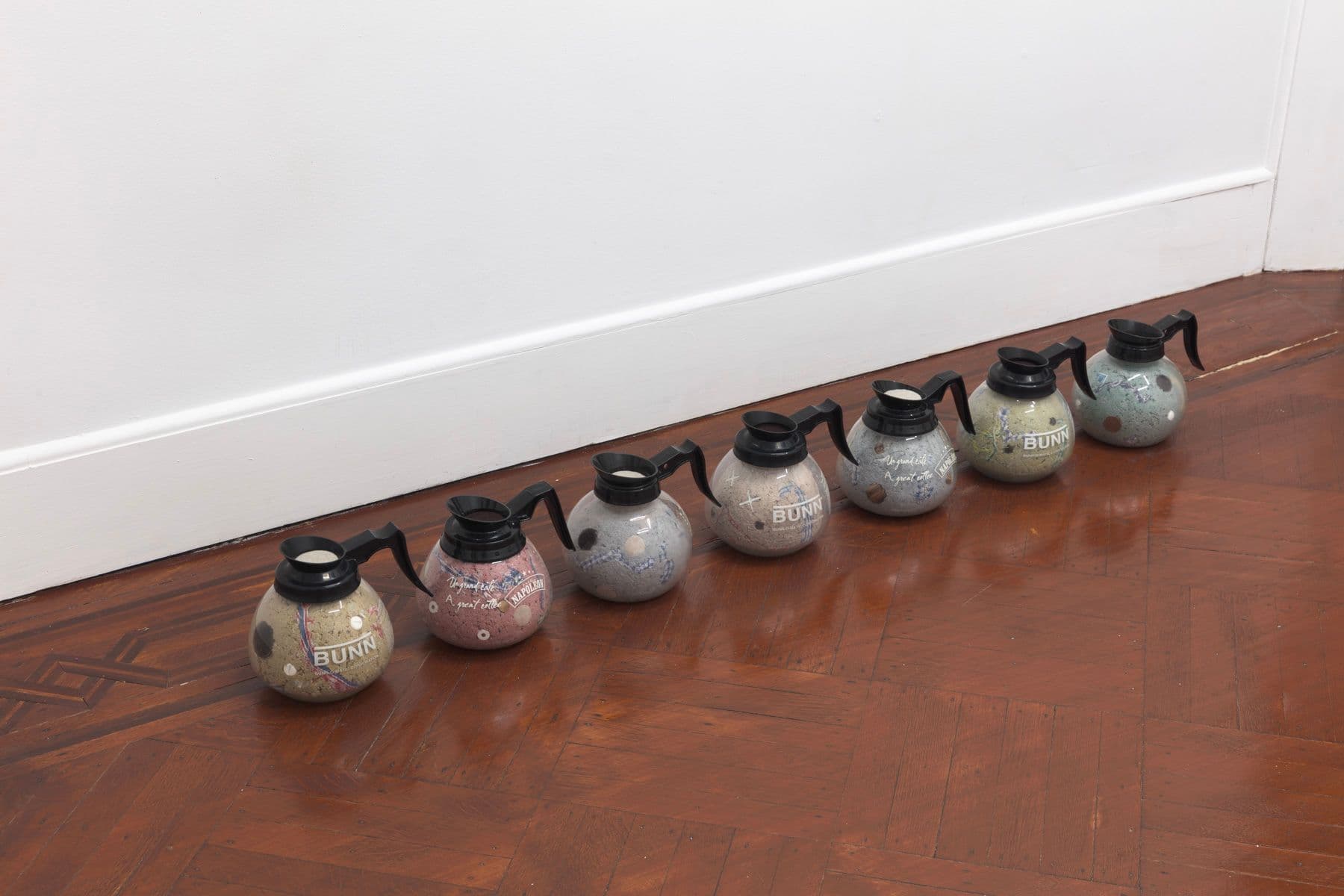 Bronson Smillie. Footnotes (1-7), 2023. Coffee decanters, paper pulp, bar rags, felt pads, postage stamps, plastic, wood. Overall dimensions variable; 7 x 8 x 8 inches each.