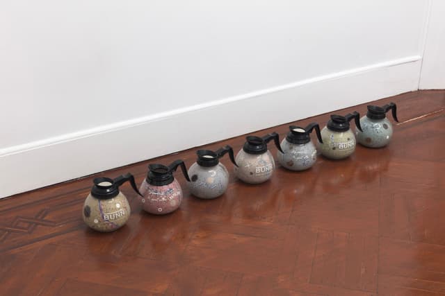 Bronson Smillie. Footnotes (1-7), 2023. Coffee decanters, paper pulp, bar rags, felt pads, postage stamps, plastic, wood. Overall dimensions variable; 7 x 8 x 8 inches each.