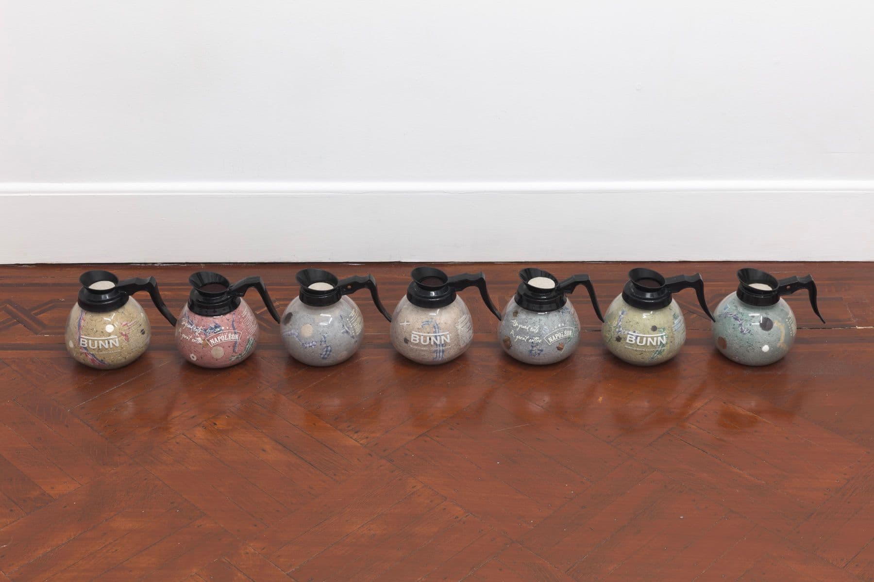 Bronson Smillie. Footnotes (1-7), 2023. Coffee decanters, paper pulp, bar rags, felt pads, postage stamps, plastic, wood. Overall dimensions variable; 7 x 8 x 8 inches each.