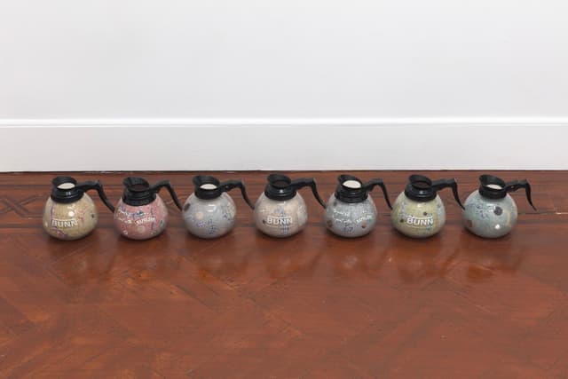 Bronson Smillie. Footnotes (1-7), 2023. Coffee decanters, paper pulp, bar rags, felt pads, postage stamps, plastic, wood. Overall dimensions variable; 7 x 8 x 8 inches each.