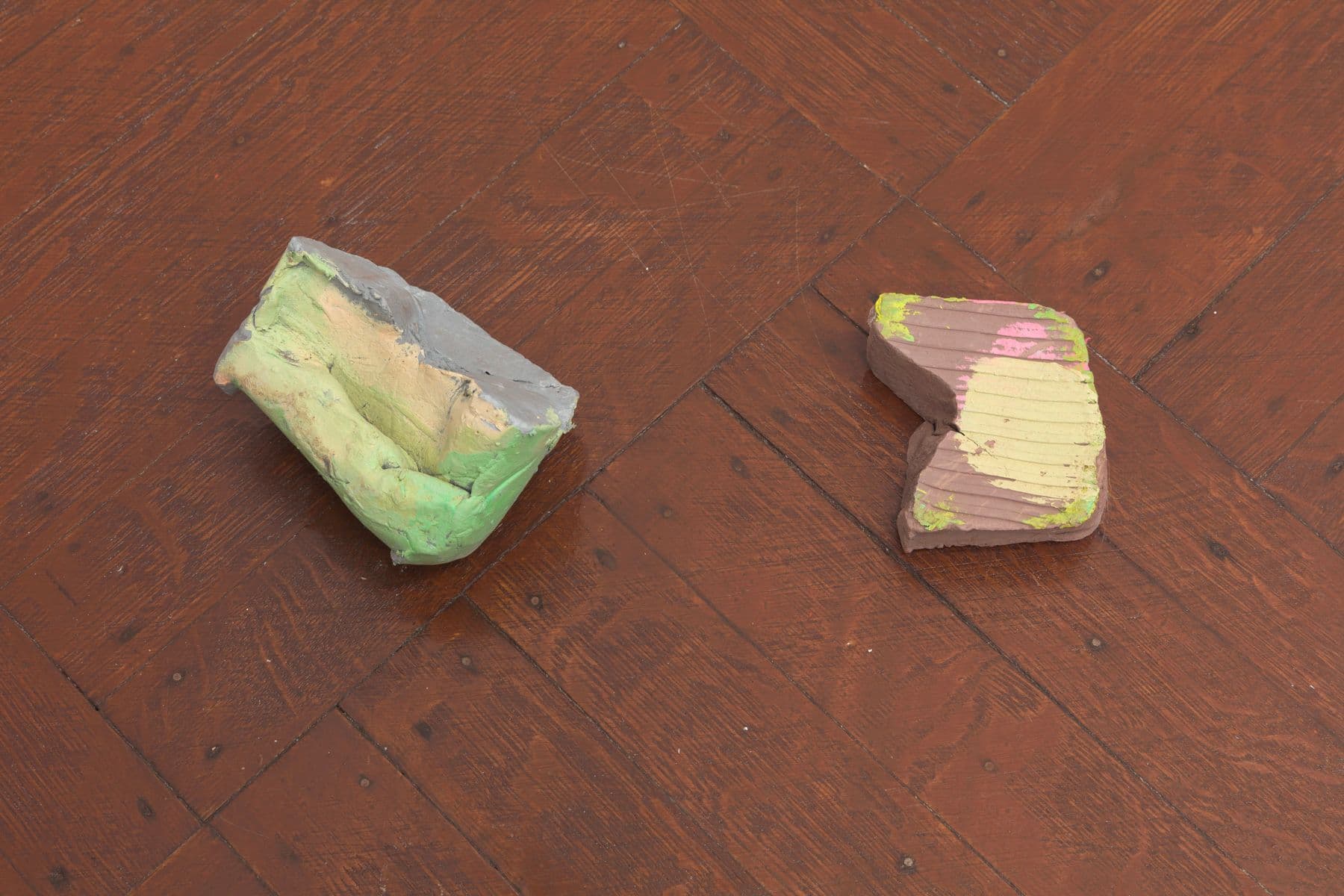 Laura McCoy. Capital Problem (Detail), 2022. Clay, acrylic paint, plastic, flowers. Dimensions variable.