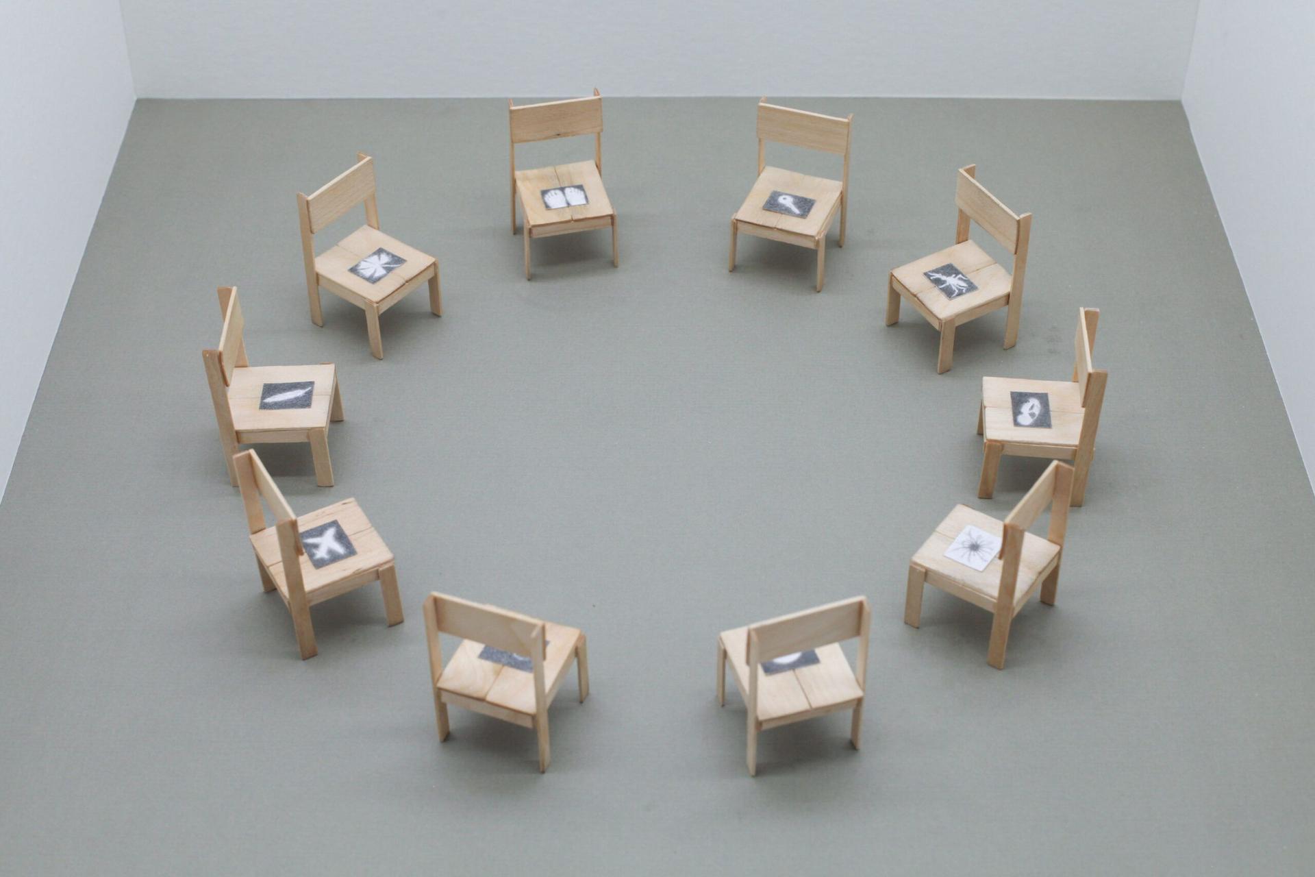 Lai Yu Tong. The World, 2023. 10 birchwood chairs, graphite on paper. 2.75 x 1.5 x 1.5 inches each.