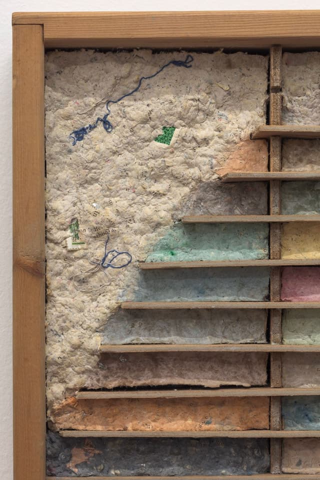 Bronson Smillie. Debris Flow Hotel (Detail), 2023. Modified cassette storage case, paper pulp, bar rag, postage stamp, felt pad. 18.5 x 24 x 3 inches.