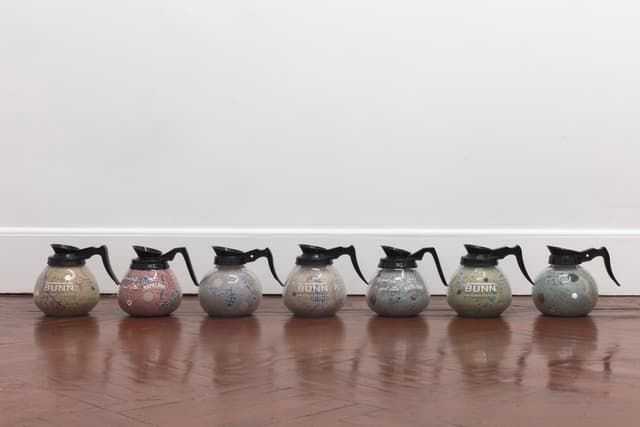 Bronson Smillie. Footnotes (1-7), 2023. Coffee decanters, paper pulp, bar rags, felt pads, postage stamps, plastic, wood. Overall dimensions variable; 7 x 8 x 8 inches each.