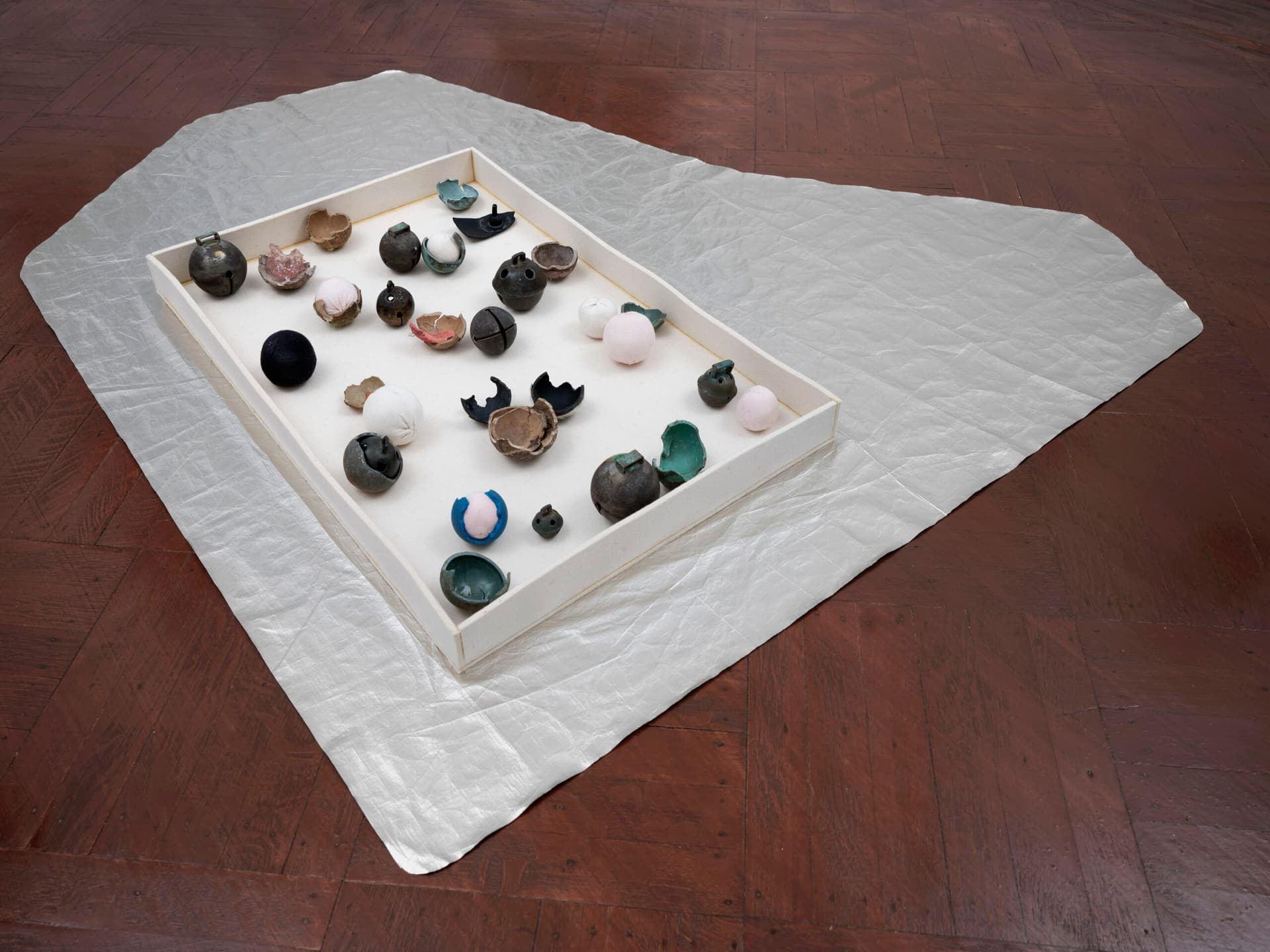 Winona Sloane Odette. Untitled, 2023. Tvyek, industrial felt, rubber ball discards, assorted bells, socks, poly batting. 48 x 56 x 1.5 inches.