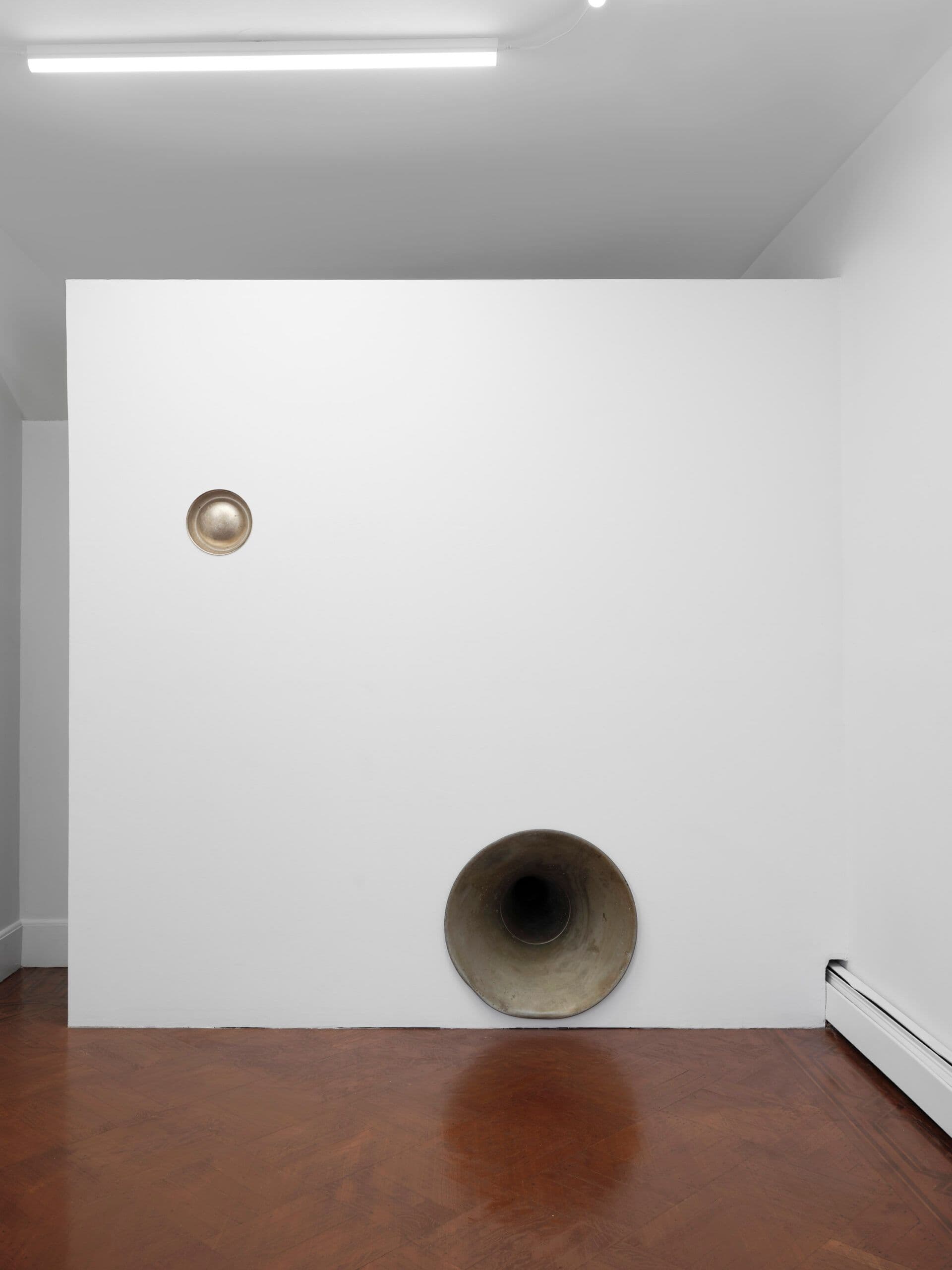 Winona Sloane Odette. Untitled, 2023. Silver plated dog bowl, phonograph horn, drywall. Dimensions variable.