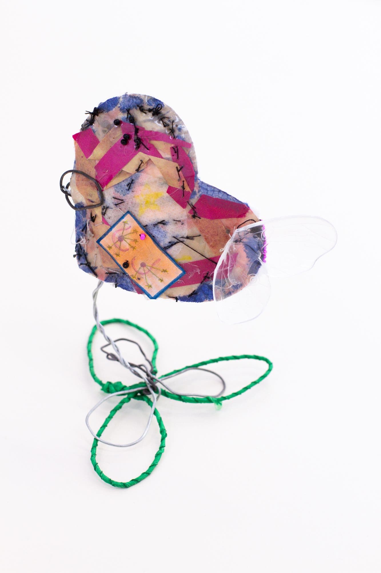 Alix Van Der Donckt-Ferrand. Untitled, 2023. Nipple cover, paper ribbon, marker, paper, plastic butterfly wing, beads, cotton, thread, wire. 4.5 x 3 x 3 inches.