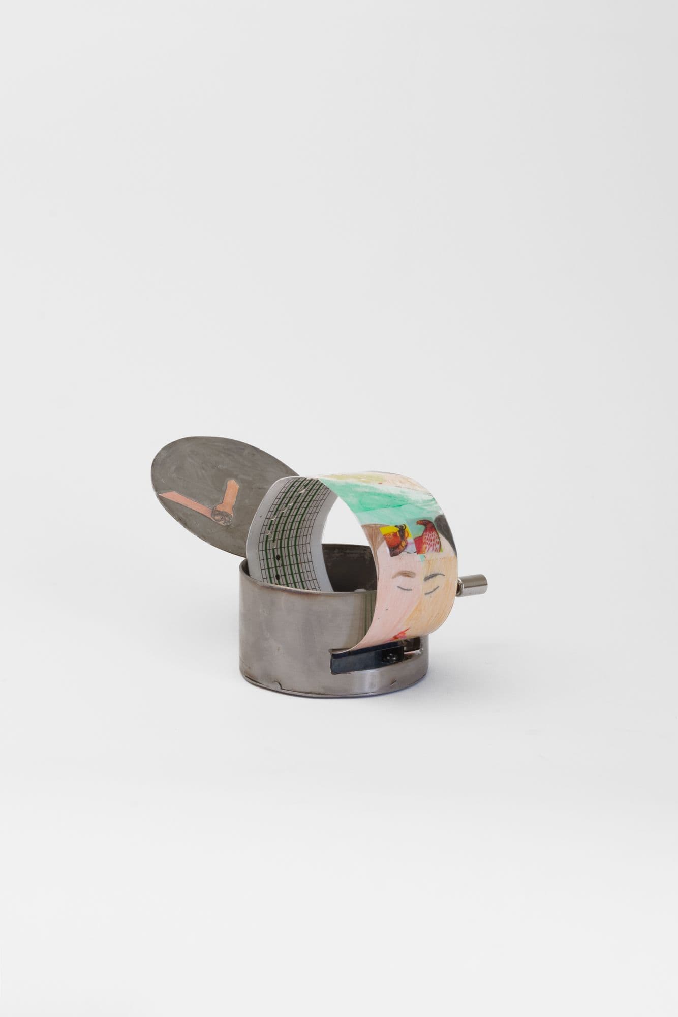 Alix Van Der Donckt-Ferrand. Quand il veut serrer son bonheur il le broie, 2025. Color pencil and graphite on paper, ribbons, steel music box. 4 x 4 x 2 inches.