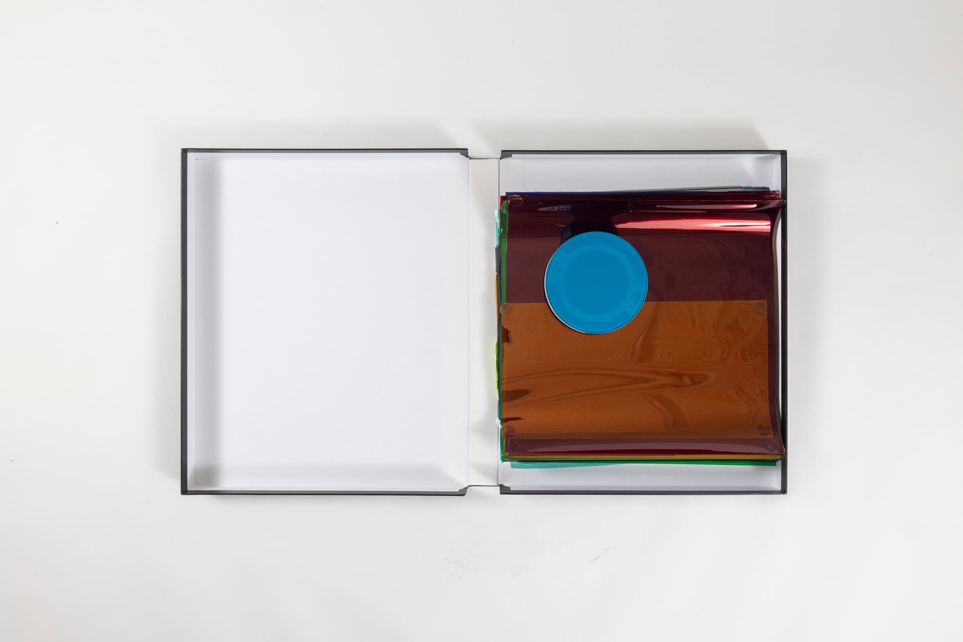 Margaret Honda. <i>Retired Work</i>, 2021-2023. Film (Fluentum), 2021, 36 Rosco and Lee lighting gels, 4-page score; Wildflowers (NG), 2015, color composite 16mm film print, 100 feet on core in can; Film (Basel Social Club), 2023, 236 Polyester gels, 5-page score. 2.375 × 24.875 × 43.375 inches. Courtest of the artist and Galerie Molitor, Berlin.