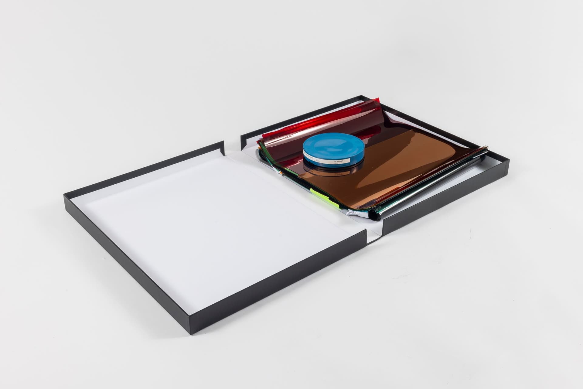 Margaret Honda. Retired Work, 2021-2023. Film (Fluentum), 2021, 36 Rosco and Lee lighting gels, 4-page score; Wildflowers (NG), 2015, color composite 16mm film print, 100 feet on core in can; Film (Basel Social Club), 2023, 236 Polyester gels, 5-page score. 2.375 × 24.875 × 43.375 inches. Courtest of the artist and Galerie Molitor, Berlin.