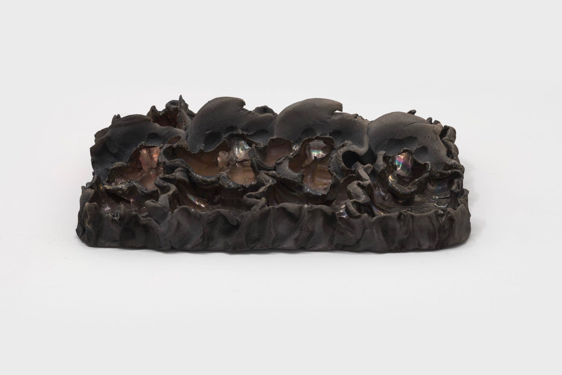 Lizette Hernández. Caricias, 2023. Raku fired 
 earthenware. 12 x 8.5 x 3 inches.