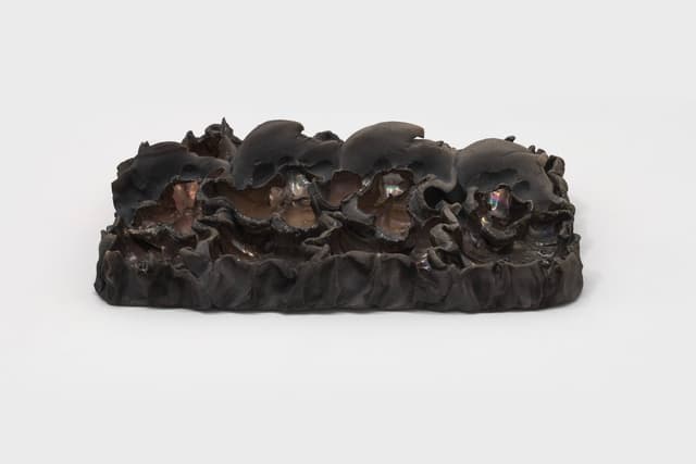 Lizette Hernández. Caricias, 2023. Raku fired 
 earthenware. 12 x 8.5 x 3 inches.
