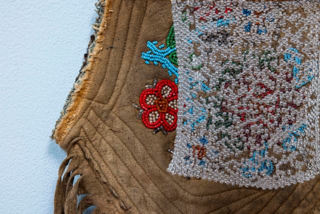 Audie Murray. Detail of <i>Net Charm; <</i>, 2025. Glass beads, thread, copper, reutilized beadwork from an unknown artist. 13 × 8 × 3 inches.