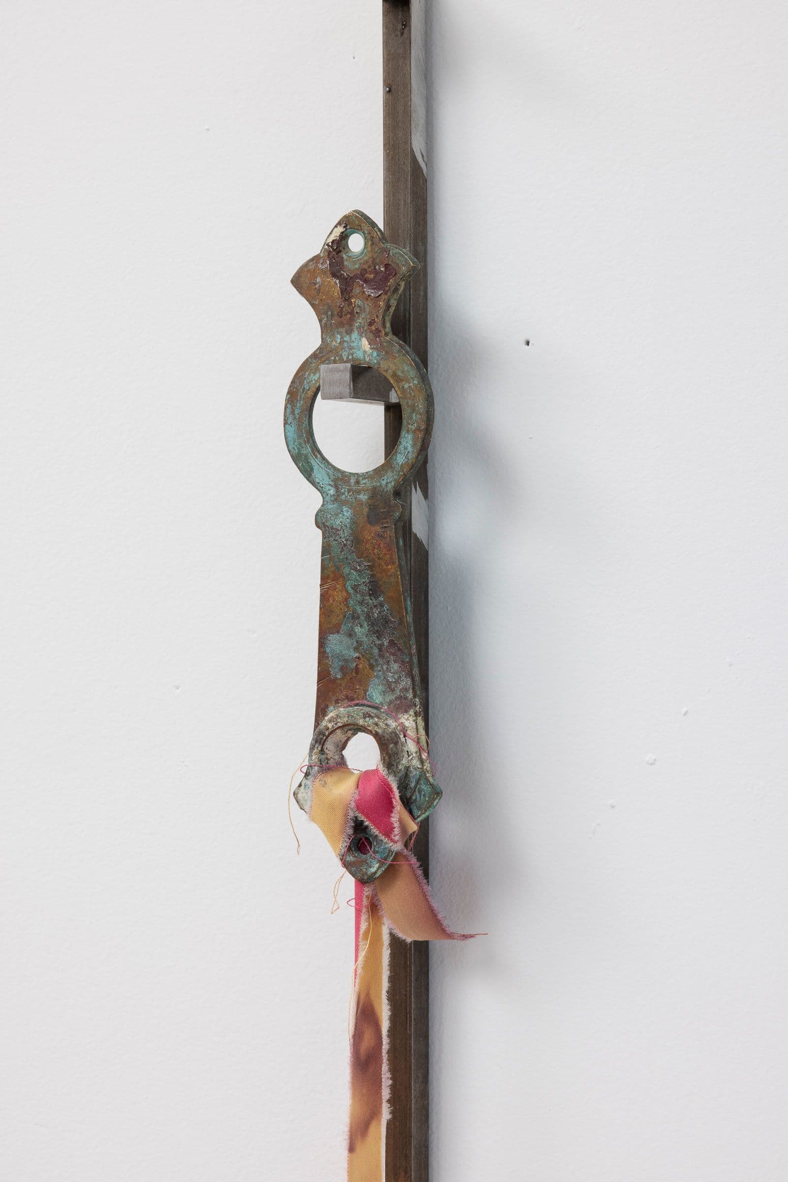 Marisa Kriangwiwat Holmes. Staff (Detail), 2024. Iron, ceramic, keys, metal locks, enamel paint, hand-dyed fabric. 77 × 5.5 inches.