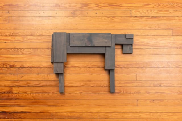 Lai Yu Tong. Dog (Greywash), 2025. Emulsion paint on pine wood. 4 3/4 × 31 1/2 × 23 1/2 inches. Courtesy the artist and ShanghART, Singapore.