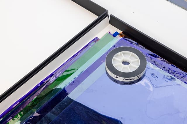 Margaret Honda. Retired Work (Detail), 2016-2017. Wildflowers (NG), 2015, color composite 16mm film print, 100 feet on core; Film (Visitor Welcome Center), 2017, 90 Rosco and Lee lighting gels, 2-page score; Film (SpazioA), 2017, 33 Rosco CalColor gels, 1-page score; Film (FAHRBEREITSCHAFT), 2017, 33 Rosco CalColor gels, 2-page score. 2 × 21.75 × 42.75 inches. Courtesy of the artist and Galerie Molitor, Berlin.