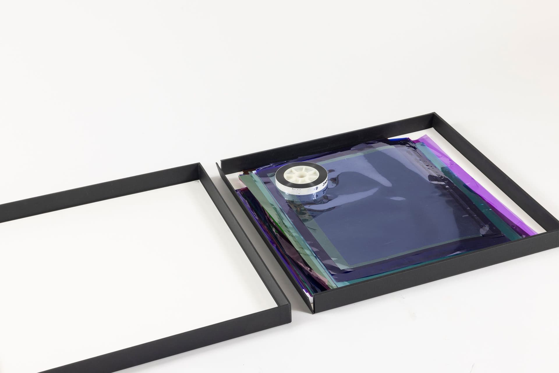 Margaret Honda. Retired Work (Detail), 2016-2017. Wildflowers (NG), 2015, color composite 16mm film print, 100 feet on core; Film (Visitor Welcome Center), 2017, 90 Rosco and Lee lighting gels, 2-page score; Film (SpazioA), 2017, 33 Rosco CalColor gels, 1-page score; Film (FAHRBEREITSCHAFT), 2017, 33 Rosco CalColor gels, 2-page score. 2 × 21.75 × 42.75 inches. Courtesy of the artist and Galerie Molitor, Berlin.