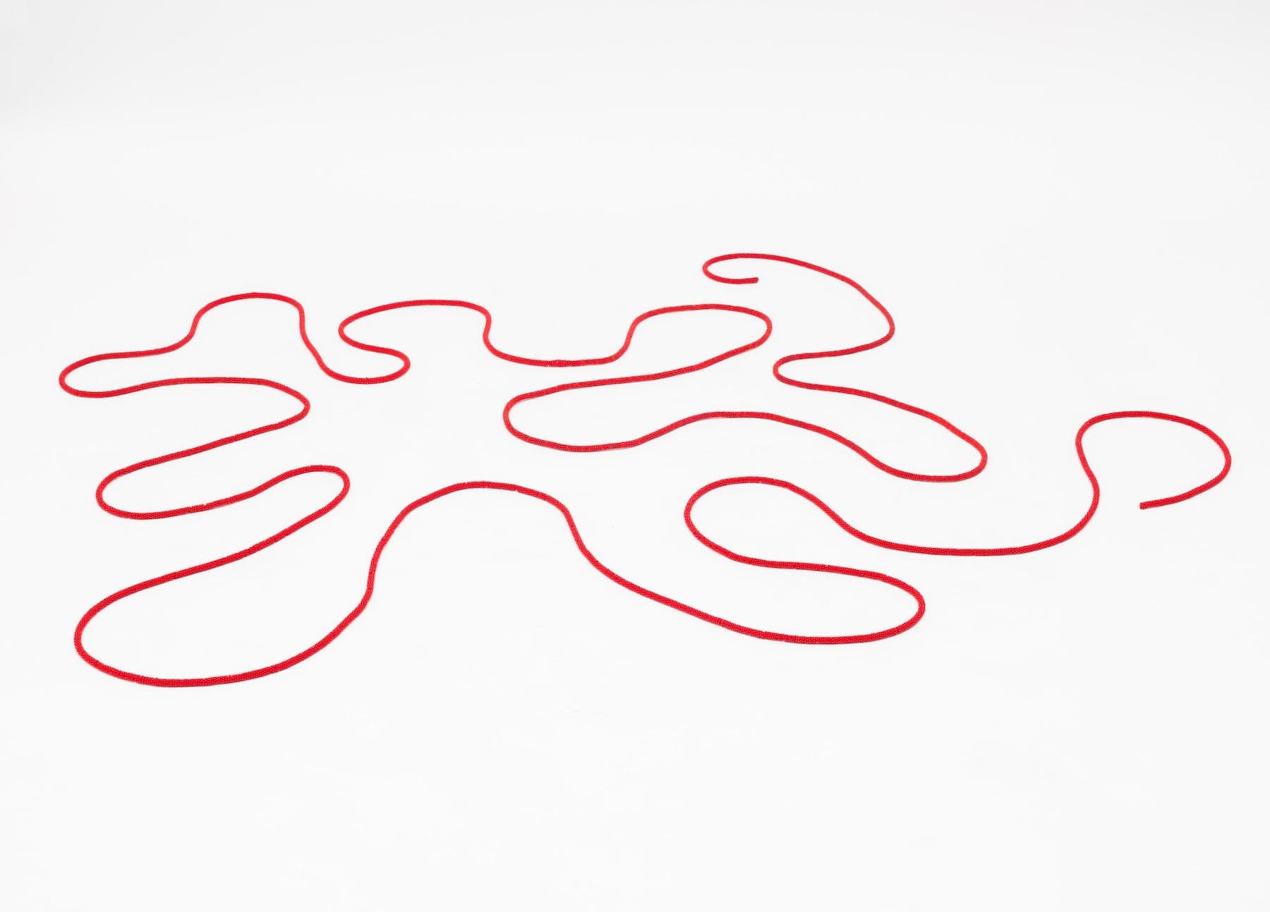 Faye HeavyShield, <i>the red line II</i>, 2025. Beads, thread, .25 × 342 inches, dimensions variable.