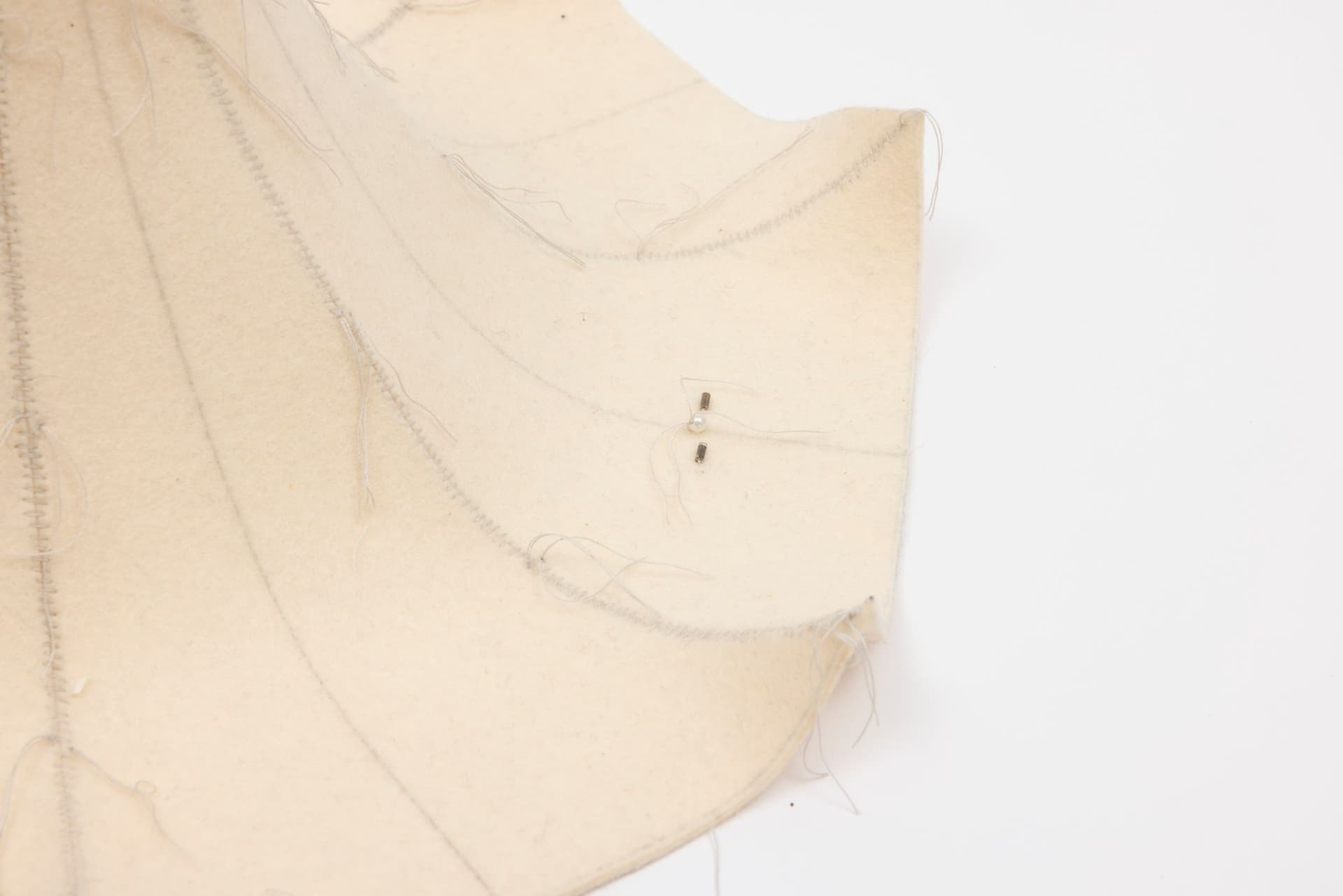 Cyrilla Mozenter. More saints seen 18 (Detail), 2004. Pencil on industrial wool felt hand stitched with silk thread, wooden craft stick and toothpick, button, pearls, and bugle beads. 13.5 × 16 × 16 inches.