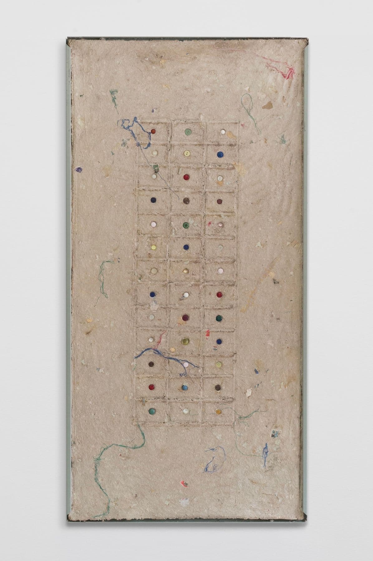 Bronson Smillie. <i>Debris Flow Wall Panel II</i>, 2026. Paper pulp, buttons, bar rag, postage stamps, metal shelf. 48 × 24 inches.