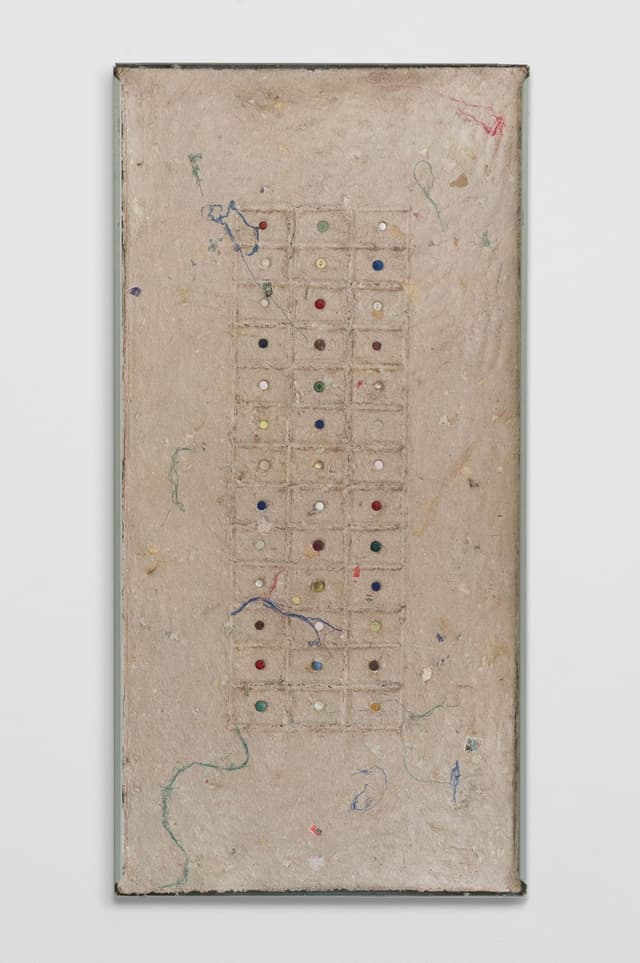 Bronson Smillie. <i>Debris Flow Wall Panel II</i>, 2026. Paper pulp, buttons, bar rag, postage stamps, metal shelf. 48 × 24 inches.