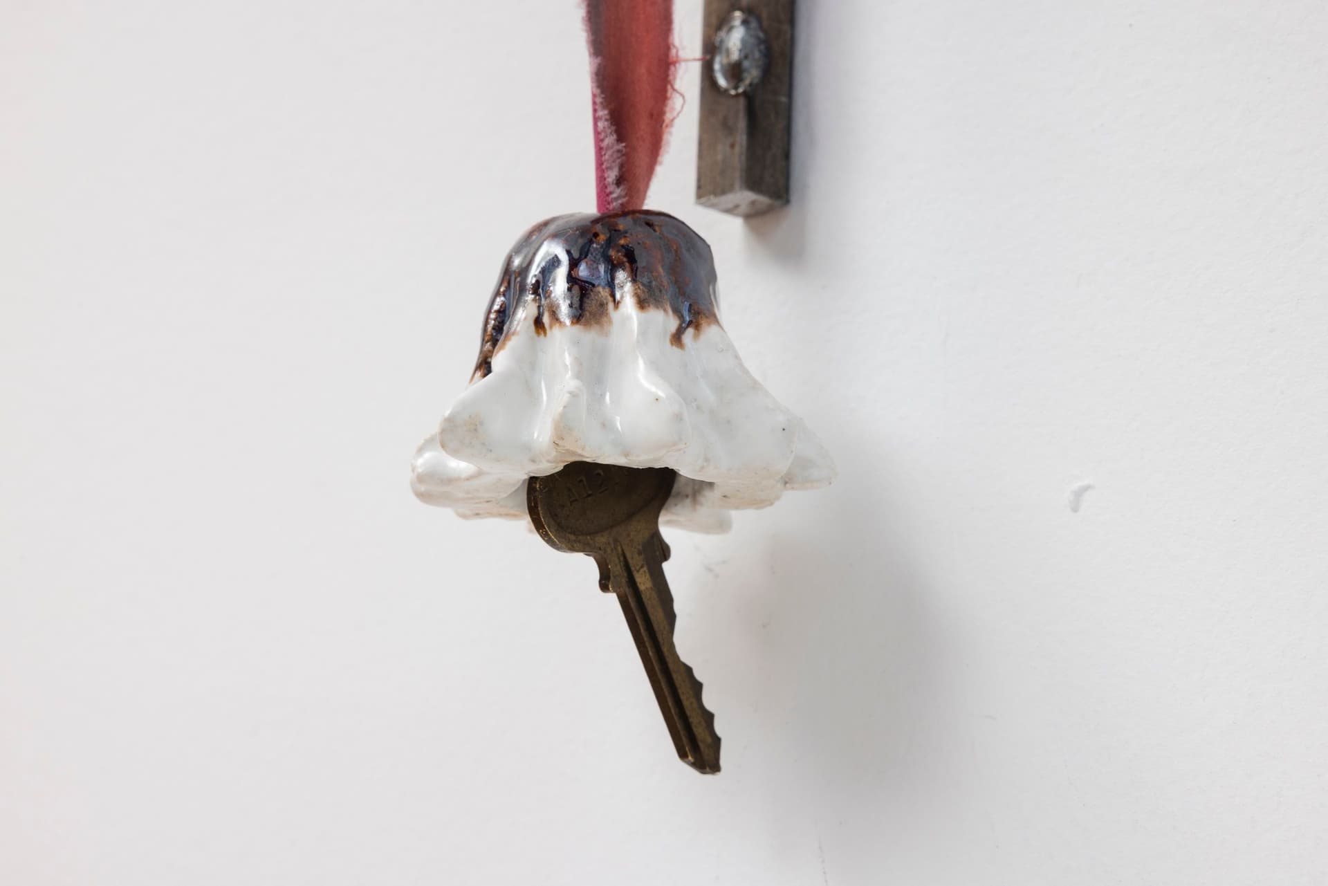 Marisa Kriangwiwat Holmes. Staff (Detail), 2024. Iron, ceramic, keys, metal locks, enamel paint, hand-dyed fabric. 77 × 5.5 inches.