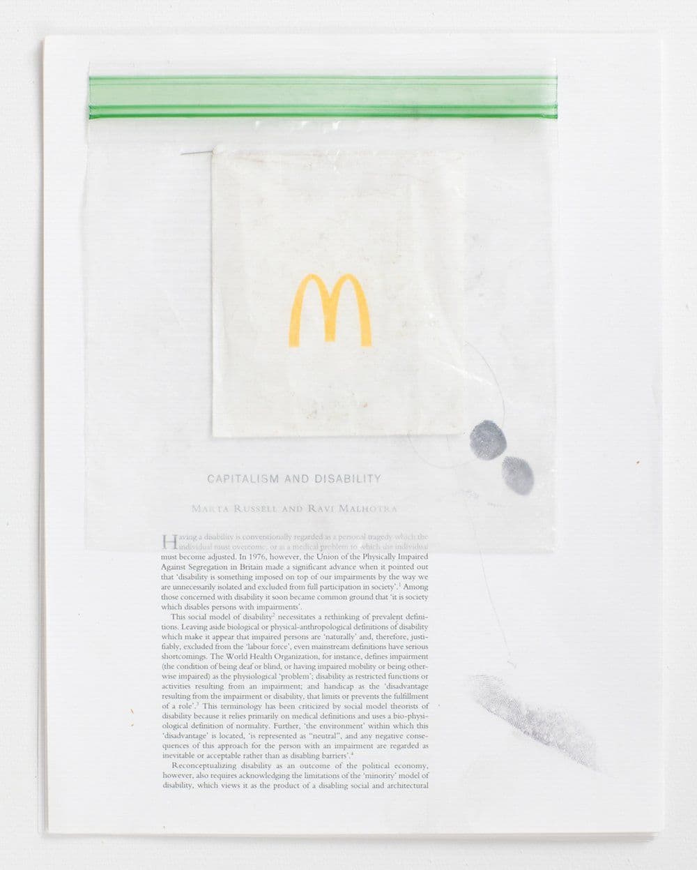 Mo Costello. Untitled (Capitalism and Disability), 2017. Text (Capitalism and Disability from the Selected Writings of Marta Russell), Plastic Bag, Found Object, Graphite, Ink, Staple. 8.5 x 11 inches.