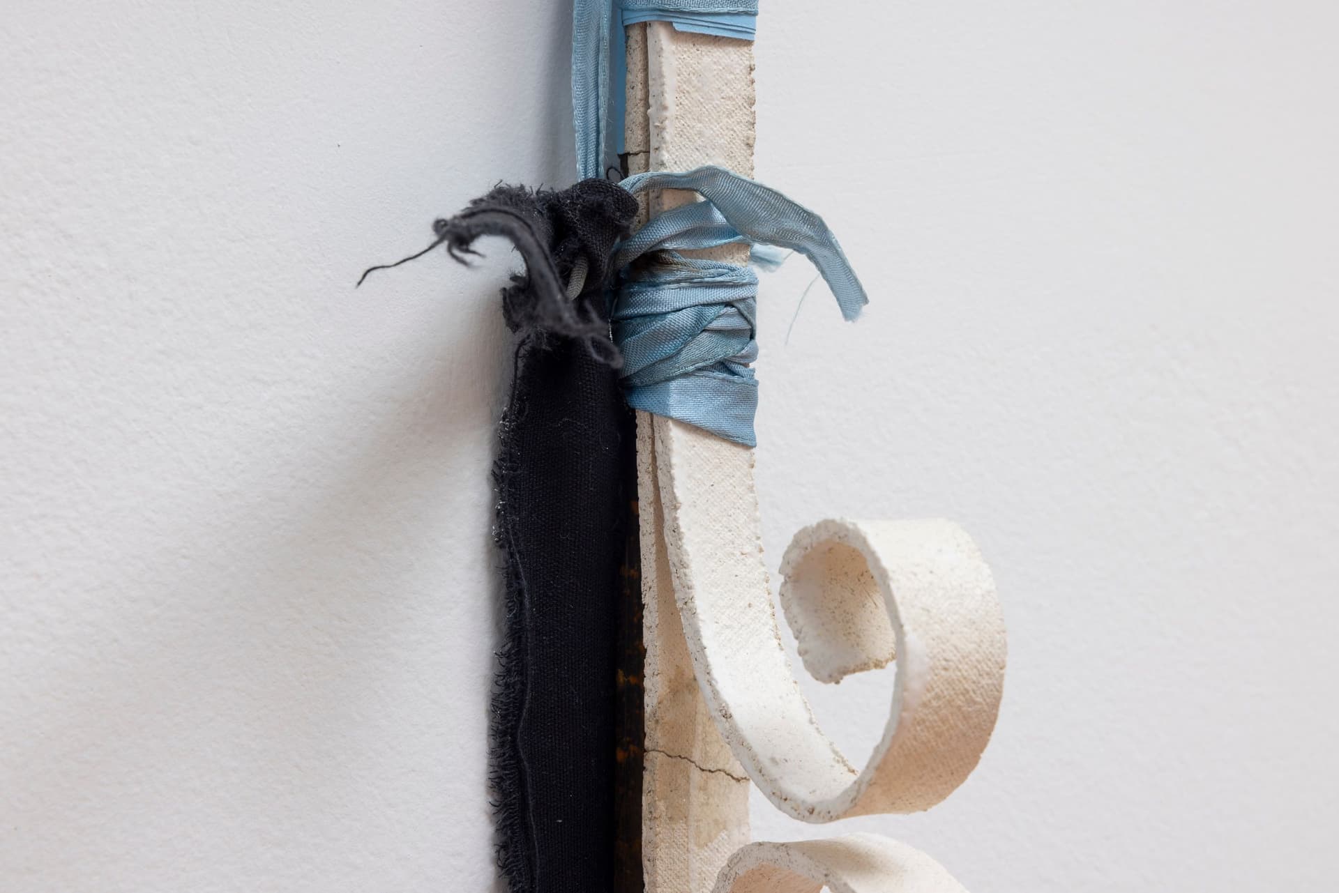 Marisa Kriangwiwat Holmes. Bells Ring (Detail), 2024. Iron, door locks, ceramic bells and fence curls, keys, hand-dyed fabric, wooden peg. 83 × 80 inches.