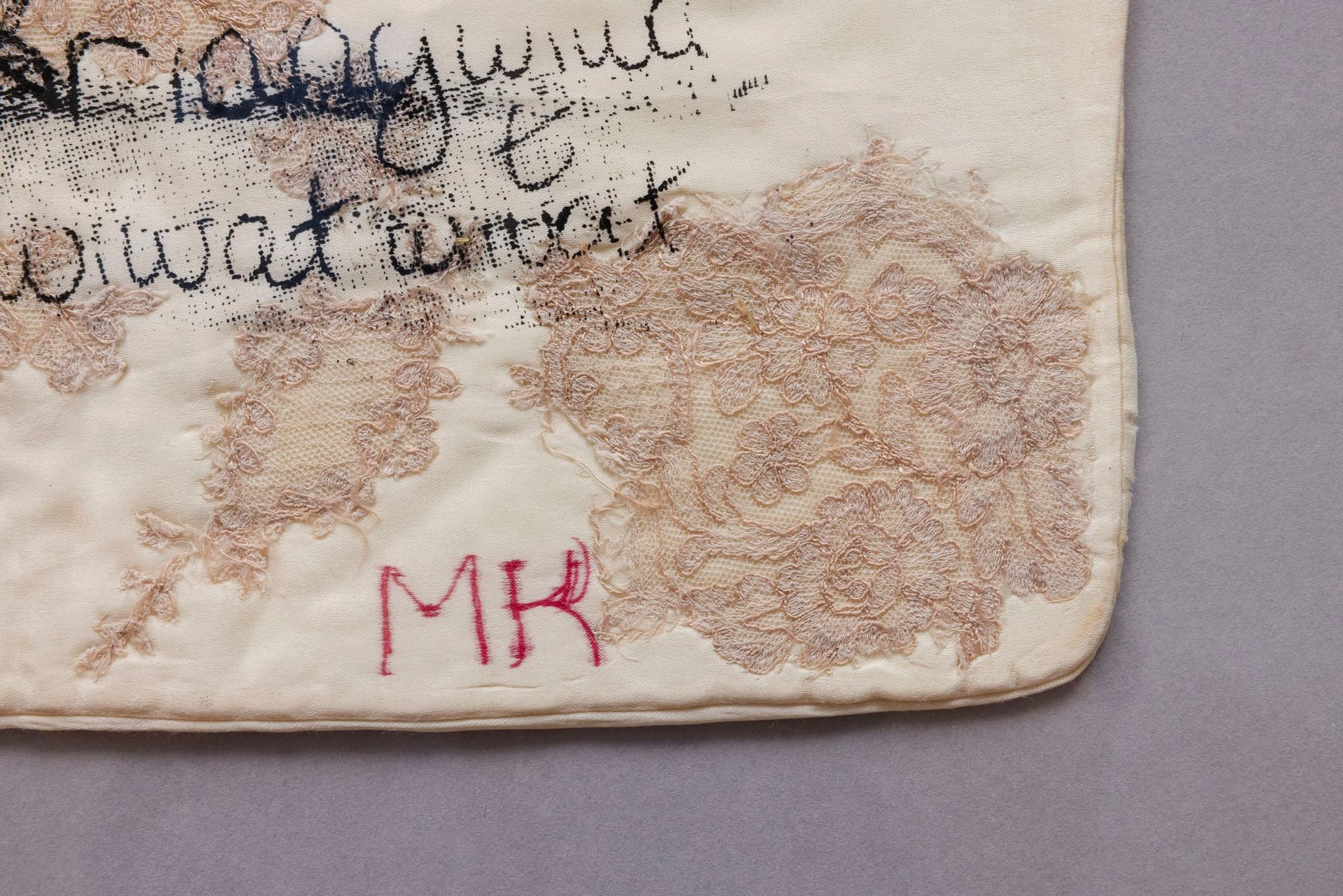 Marisa Kriangwiwat Holmes. Sick Note (Detail), 2024. Silkscreen on silk and lace pillow, hand-colored card stock, acrylic frame. 30.25 × 20.5 inches.