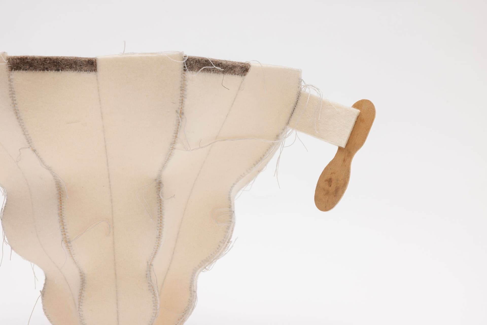 Cyrilla Mozenter. More saints seen 29 (Detail), 2005. Pencil on industrial wool felt hand stitched with silk thread and wooden ice cream spoons. 8.5 × 15.5 × 10.75 inches.