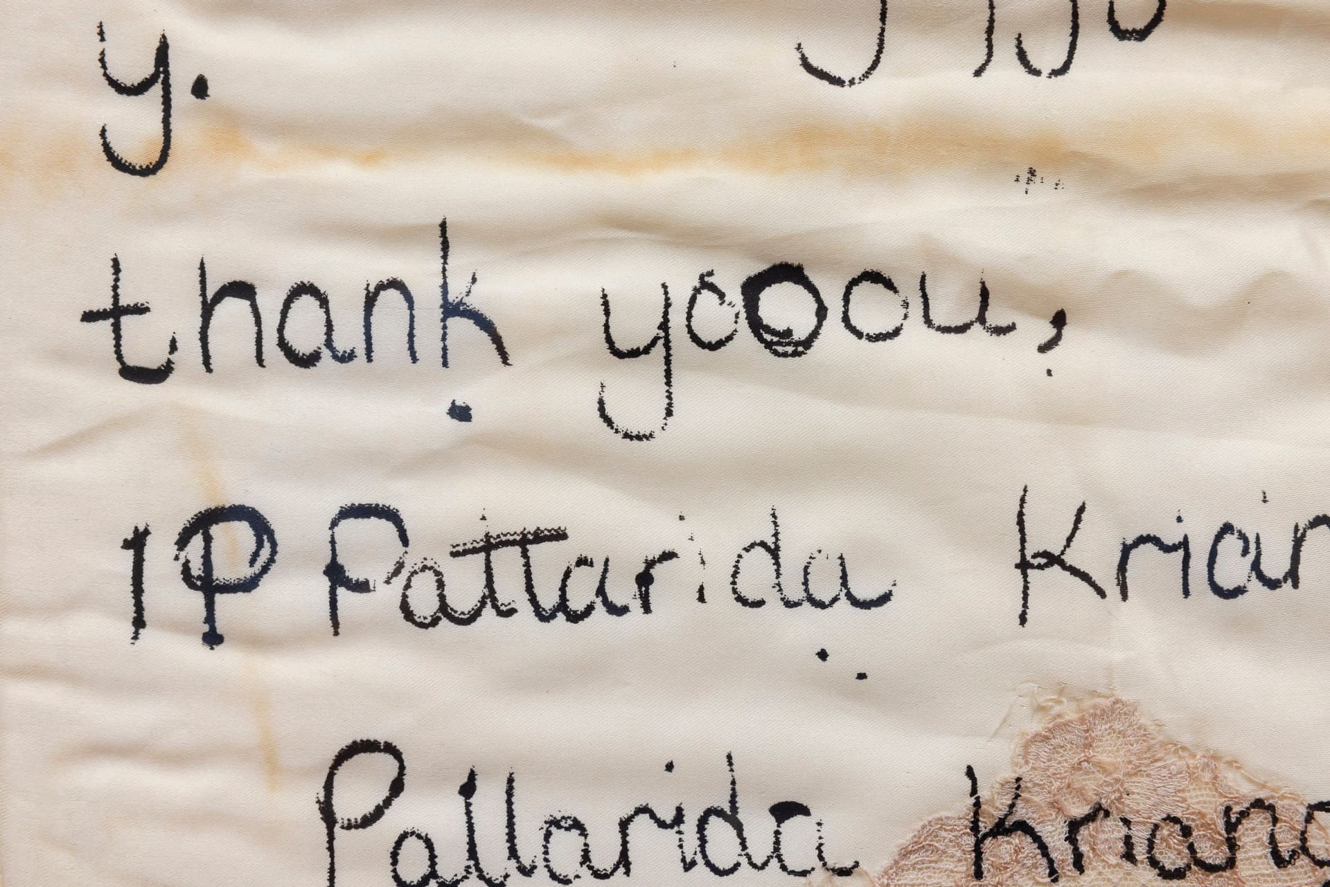 Marisa Kriangwiwat Holmes. Sick Note (Detail), 2024. Silkscreen on silk and lace pillow, hand-colored card stock, acrylic frame. 30.25 × 20.5 inches.